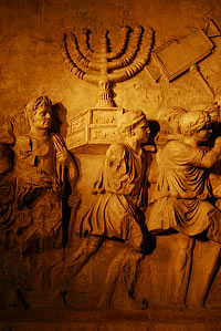 Sculptures on the wall of the Arch of Titus in Rome. Carrying away the temple treasures